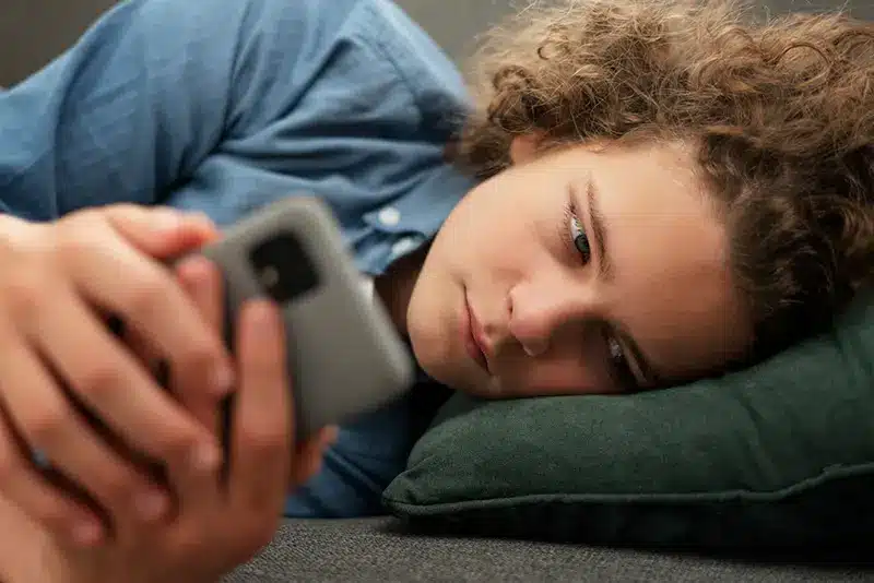Young man discouraged while scrolling on his phone